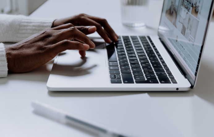 Black women typing on laptop